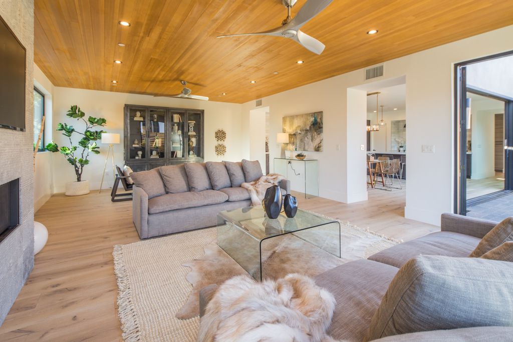 Light hardwood flooring in a spacious living room with a dog | Bay Country Floors